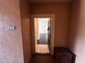 Condo entryway featuring neutral tones, tiled floors and views into the living room at 5560 Metrowest Blvd # 3-204, Orlando, FL 32811