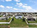 Aerial view of the backyard and neighborhood showcasing location, privacy, and community layout at 605 Black Eagle Dr, Groveland, FL 34736