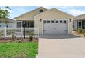 Inviting single-story home with a white picket fence, two-car garage, and manicured lawn at 6301 Whittle Ct, The Villages, FL 32163