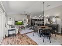 Bright open concept living area with luxury vinyl floors open to dining area and kitchen at 6301 Whittle Ct, The Villages, FL 32163