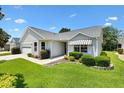 Charming single story home featuring a well-maintained lawn and attached garage at 654 Fayette Ct, The Villages, FL 32162