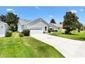 Well-maintained single story home with a two car garage and mature landscaping at 654 Fayette Ct, The Villages, FL 32162