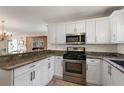 Modern kitchen with stainless steel appliances, granite counters, and open layout at 851 Evelynton Loop, The Villages, FL 32162