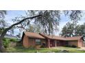 Quaint single-story home with brick accents and mature landscaping at 901 Baylor Dr, Deltona, FL 32725