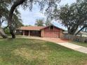Charming single-story home with a brick driveway and mature trees at 901 Baylor Dr, Deltona, FL 32725