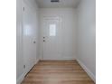 Bright entryway with fresh white paint, modern lighting, wood floor, and ample closet space at 9144 Sw 156Th Pl, Dunnellon, FL 34432