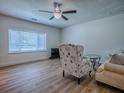 Cozy living room featuring a large window, a modern ceiling fan, and stylish furniture at 9144 Sw 156Th Pl, Dunnellon, FL 34432
