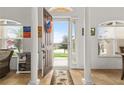 Bright foyer with tile flooring, arched windows, and a view of the front yard at 10240 Kabana Blvd, Clermont, FL 34711