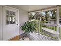 Cozy porch with views of the well maintained backyard, featuring a unique decorative bathtub at 10303 Se Sunset Harbor Rd, Summerfield, FL 34491