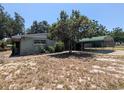 Exterior view of the property showing a carport, some greenery, and the side of the house at 1095 Golden Isle Dr, Mount Dora, FL 32757