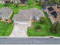An aerial view shows this home's lush, green landscaping, 3-car garage and well-kept lawn at 11019 Se 170Th Lane Rd, Summerfield, FL 34491