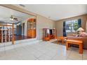 Open-concept living room showcasing dining area, hardwood floors, and neutral paint at 1119 Pine Ave, Tavares, FL 32778