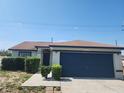 Charming single-story home with blue garage door, landscaped front, and bright blue skies at 112 Arlington Ct, Haines City, FL 33844