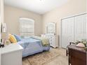 Cozy bedroom featuring a comfortable bed, dresser, and a window for natural light at 11215 Se 172Nd Place, Summerfield, FL 34491