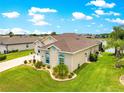 Aerial view of a well-maintained single-story home, showcasing its backyard, lawn, and landscaping at 11215 Se 172Nd Place, Summerfield, FL 34491
