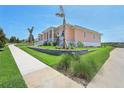 Inviting peach-colored home with manicured lawn and retaining wall landscaping at 1127 Fiesta Key Cir, Lady Lake, FL 32159