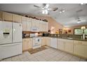 Well-lit kitchen with white cabinets and appliances, plus ample counter space for cooking at 11495 Se 71St Terrace Rd, Morriston, FL 32668