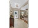 Inviting foyer features a decorative front door, tiled floor, and views into the adjacent seating area at 11601 Thacker Dr, Clermont, FL 34711