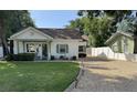 Inviting single-story home boasting a well-kept lawn, gravel driveway, and freshly painted exterior at 1339 Orchid Ave, Winter Park, FL 32789