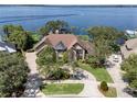 An aerial view shows the home's location with waterfront access and a long, private driveway at 1956 Brantley Cir, Clermont, FL 34711