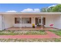 Inviting front porch with decorative ironwork and brick accents, providing a charming entrance to the home at 2022 Edgewood Rd, Leesburg, FL 34748