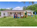 Single story home featuring a well-maintained lawn and colorful outdoor play equipment at 2022 Edgewood Rd, Leesburg, FL 34748