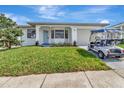 Beautiful one story home with a green lawn and a golf cart in the driveway at 2235 Harbor Town Ln, Lakeland, FL 33810