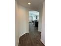 A welcoming hallway featuring wood flooring and an archway leading to the living area at 2441 Nellie Rd, The Villages, FL 32163