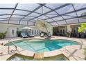 Inviting screened-in pool with stone surround and lounge area perfect for relaxation and entertainment at 2904 Avalos Dr, The Villages, FL 32162