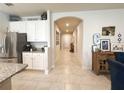 Hallway view highlighting tile flooring, arched entryway, and neutral paint tones at 3181 Hill Point St, Minneola, FL 34715