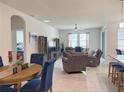 Spacious living room features tile floors, ceiling fan, and large windows for natural light at 3181 Hill Point St, Minneola, FL 34715
