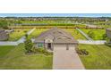Stunning aerial view showcasing the home, lush landscaping, and fenced yard near community pond at 3222 San Leo Dr, Orlando, FL 32820