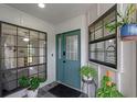 Inviting entryway featuring a teal front door, sidelight windows, and stylish interior accents at 33 Palm Dr, Yalaha, FL 34797