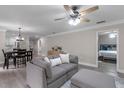 Open concept living area with modern furniture, wood-look floors, and ample natural light at 33 Palm Dr, Yalaha, FL 34797