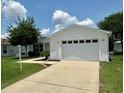 Charming home exterior featuring a well-maintained lawn and two car garage at 3337 Candlebrook St, The Villages, FL 32162