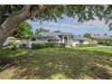 Beautiful single-story home with well-maintained lawn and mature trees offering shade and privacy at 33913 Sabal Way, Leesburg, FL 34748