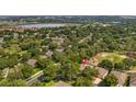 An aerial view of the neighborhood shows the beautiful landscaping, nearby lake, and well-maintained community at 3607 Fairfield Dr, Clermont, FL 34711