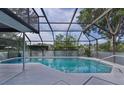 Relaxing screened-in pool area with a clear blue pool and outdoor lounging space at 36535 Eagle Dr, Grand Island, FL 32735