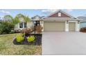 Inviting single-story home with a two-car garage and lush landscaping at 3769 Causey Ct, The Villages, FL 32163
