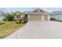Well-maintained single-story home with a spacious driveway and landscaped front yard at 3769 Causey Ct, The Villages, FL 32163