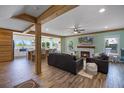Open-concept living area with a fireplace, hardwood floors, and seamlessly connects to the kitchen at 378 W Osceola St, Clermont, FL 34711