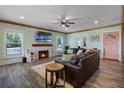 Inviting living room featuring a stone fireplace, wood beam accents, and stylish furnishings at 378 W Osceola St, Clermont, FL 34711