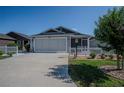 Beautiful home with a two-car garage, screened porch, and lovely landscaping at 3817 Miragalia Ln, The Villages, FL 32163