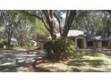 Exterior front view of property with mature trees and landscaping at 3930 Griffin Ave, Lady Lake, FL 32159