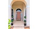 Inviting front entrance with stylish decor and lush greenery at 3969 Derby Glen Dr, Clermont, FL 34711