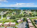 Scenic aerial view of the community with lake views, lush trees, and well-maintained buildings at 500 Newell Hill Rd # 113D, Leesburg, FL 34748