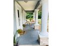 Inviting front porch features seating, creating a cozy outdoor space at 5051 Nw 61St Ct, Ocala, FL 34482