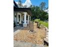 Close-up of front yard landscaping, with rock beds leading to the porch at 5051 Nw 61St Ct, Ocala, FL 34482