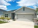 Beautiful single-story home featuring a well-maintained lawn, decorative stone accents, and a spacious two-car garage at 591 Black Eagle Dr, Groveland, FL 34736