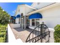 Stunning property with vibrant blue awnings over the windows and doors at 6048 Topsail Rd, Lady Lake, FL 32159